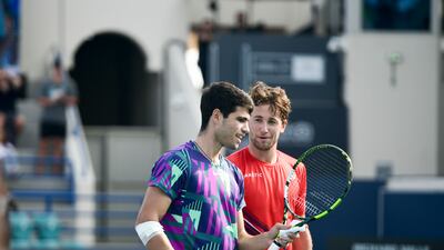 Carlos Alcaraz, left, and Casper Ruud greet each other at the net following their third-place playoff match at the Mubadala World Tennis Championships held in Zayed Sports City, Abu Dhabi. Khushnum Bhandari / The National