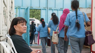 Theresa Culianan keeps an eye on the first group of women to leave for work at 5.30am. Making sure workers are well turned out and prompt are among her many daily duties. Vaida Nairn for The National