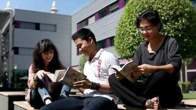 Students from the New York University Abu Dhabi read outside in a campus courtyard. Fatima Al Marzooqi / The National