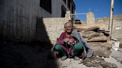 An elderly woman sits in front of her house in the village of Kibber, in Spiti Valley. Thomas Cytrynowicz / AP Photo
