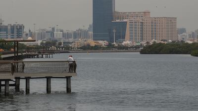 Anglers fish along the Eastern Mangroves in Abu Dhabi during a slight downpour. All photos by Victor Besa / The National