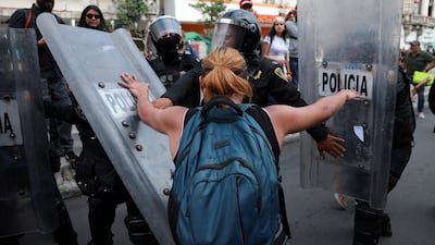A demonstrator is pressed by police officers during a protest against gentrification in Mexico City, Mexico, on July 26. Reuters
