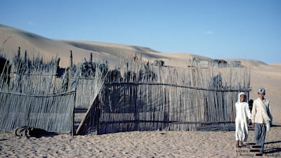 Boys beside a traditional barasti compound in Abu Dhabi in the early 1960s. Photo: Dr Alan Horan © UAE National Library and Archives