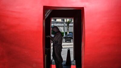 A health worker at a makeshift testing centre outside a museum in Beijing. AFP