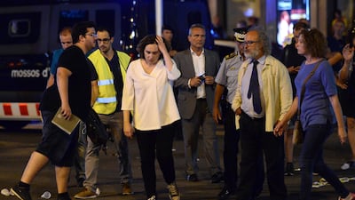 Barcelona's Mayor Ada Colau, in white, and other officials at the scene. Josep Lago