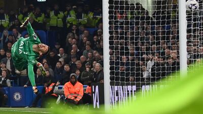 Tottenham Hotspur goalkeeper Guglielmo Vicario dives but cannot prevent a header from Chelsea defender Trevoh Chalobah. AFP
