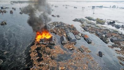 Houses burn in Sendai after Japan was struck by a tsunami following a strong earthquake off its northeastern coast .