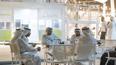 Sheikh Mohamed bin Zayed with Mohammed Al Mubarak stop for a coffee at one of A'l Bahar's cafes. Mohammed Al Hammadi / Ministry of Presidential Affairs