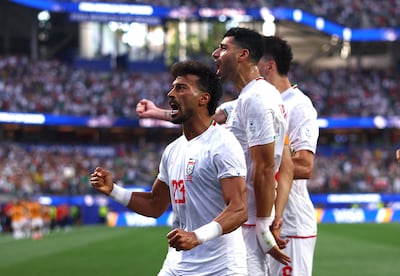 Ramin Rezaeian, front, celebrates scoring Iran's first equaliser. AFP