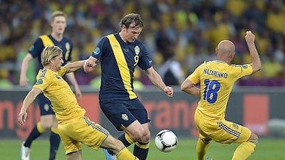 Sweden's Kim Kallstrom tussles with Ukraine's Anatoliy Tymoshchuk, left, and Serhiy Nazarenko. Martin Meissner / AP Photo