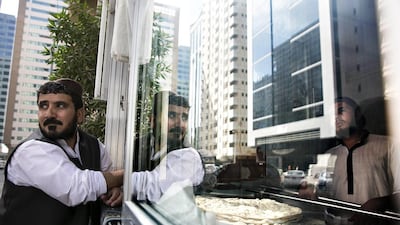 Haji Mohammad, an expatriate from Afghanistan who has baked bread in the Tourist Club district of Abu Dhabi for 17 years, now does so in Al Zahiyah after the municipality changed the area’s name. Zayed City in the capital has also been renamed Al Danah. Silvia Razgova / The National