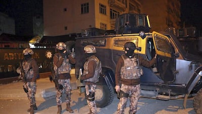 Turkish anti-terrorism police stand by their armoured vehicle during an operation to arrest people over alleged links to ISIL, in Adiyaman, southeastern Turkey, on Sunday, February 5, 2017. Mahir Alan / Dha-Depo Photos via AP