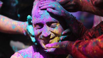 Indians smear colored powder on each other as they celebrate Holi in Jammu, India. Holi, the Hindu festival of colors, also heralds the arrival of spring. AP Photo