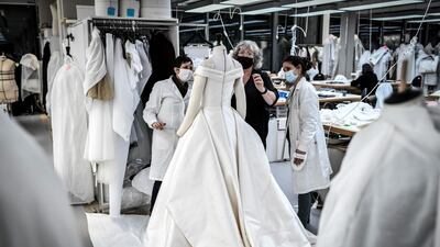 Seamstresses work on a dress at Christian Dior's Haute Couture fashion house workshop in Paris. AFP