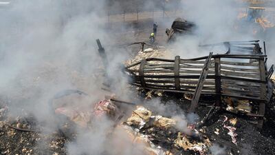 Local residents and owners of fuel tankers inspect the debris following an overnight ablaze in which several fuel tankers caught fire at Qala-e-Murad Bek area on the outskirts of Kabul. AFP