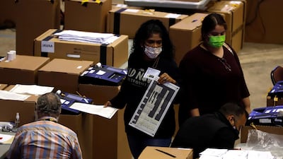 Polling station personnel prepare early voting boxes in San Juan, Puerto Rico. Citizens are voting in a general election, but have no say over who the next US president will be. EPA
