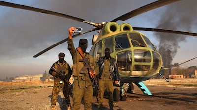 Militants gather at the Nayrab military airport, in the northern Syrian city of Aleppo. AFP