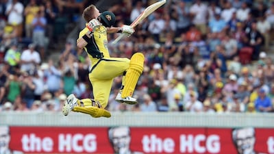 Australia's David Warner celebrates his century during the second game of the One Day International Cricket series between Australia and New Zealand in Canberra on December 6, 2016. Saeed Khan / AFP