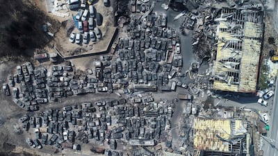 Burnt vehicles filling a junkyard after being hit by a massive forest fire are seen from above. Yonhap via AP