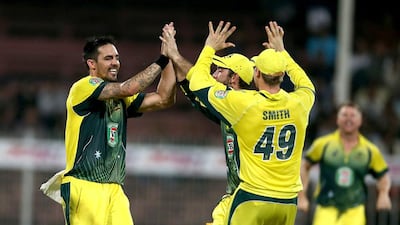 Australia’s Mitchell Johnson, left, celebrates with teammates Glenn Maxwell and Steve Smith after the wicket of Anwar Ali of Pakistan on Tuesday in Sharjah. Johnson took three wickets for 24 runs. Pawan Singh / The National