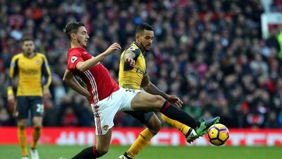 Manchester United's Matteo Darmian, left, challenges Arsenal's Theo Walcott during the English Premier League match at Old Trafford, Manchester, Britain, November 19, 2016. Nigel Roddis / EPA