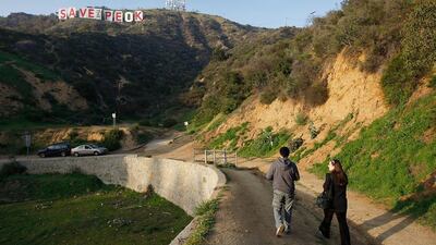 An anti-urbanisation slogan on the Hollywood sign. Anne Cusack / Los Angeles Times via Getty Images
