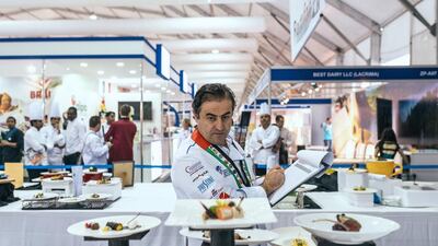 A judge reviews entries to the five-course gourmet dinner menu class of the Salon Culinaire competition at Gulfood.