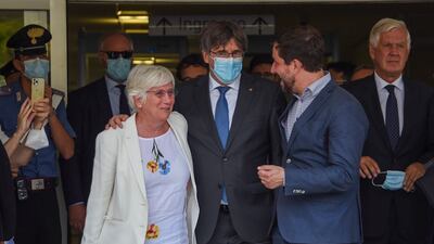 Catalan leader Carles Puigdemont, centre, flanked by European Parliament members Antoni Comin and Clara Ponsati, leaves a court in Sardinia on Monday. AP