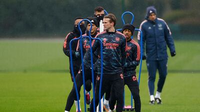 Rob Holding, Ben White and Reiss Nelson with teammates during training. Reuters
