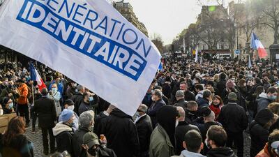 File photo: Taken on February 20, 2021, members and supporters of far right group Generation Identitaire (GI) hold a flag during a protest against its potential dissolution in Paris. AFP