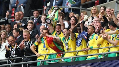 Norwich City’s Russell Martin lifts the trophy as they celebrate gaining promotion to the Premier League. Reuters / Matthew Childs