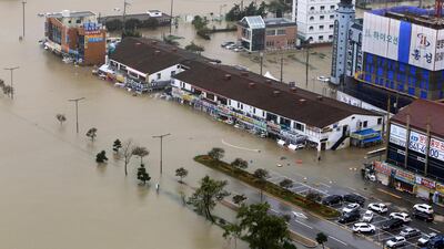 Buildings are submerged in floodwater after heavy rain in Gangneung South Korea. AP