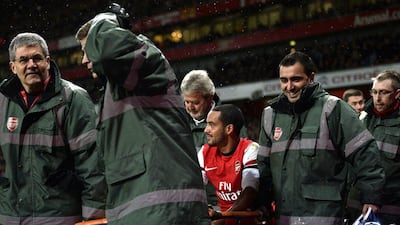Theo Walcott will miss six months after injuring his left knee against Tottenham, Arsenal announced on Monday. Dylan Martinez / Reuters