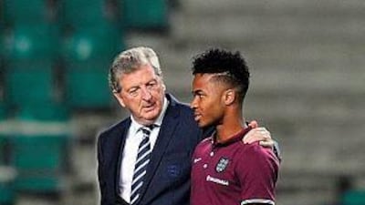 England manager Roy Hodgson, left, talks to midfielder Raheem Sterling at the A.Le Coq Arena in Tallinn, Estonia on October 11, 2014, ahead of the Euro 2016 qualifying group E football match against Estonia in Tallinn on October 12, 2014. AFP PHOTO / GLYN KIRK