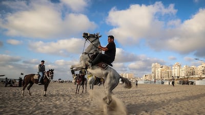 A Palestinian man rides his horse on the beach in Gaza city. AFP
