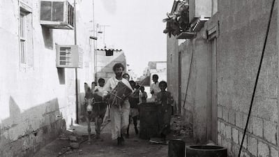 Drummer Khamees Abu Tubaila and his entourage walk the alleyways of Abu Dhabi to wake residents and prepare them for the day’s fasting. Photo: Al Ittihad