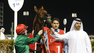 Kieren Fallon, left, guides Prince Bishop to the win for trainer Saeed bin Suroor, right, at the Meydan Racecourse on March 8, 2014. Razan Alzayani / The National