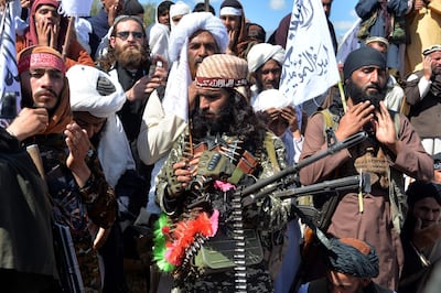 Taliban militants celebrate the peace deal and their victory in March. AFP