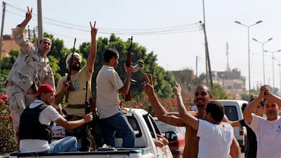 Local residents greet advancing rebel fighters on the outskirts of Tripoli, Libya, Monday, Aug. 22, 2011. Clashes broke out early Monday near Moammar Gadhafi's compound in Tripoli, a day after rebels poured into the Libyan capital in a stunning advance th???