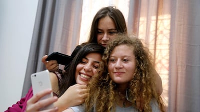 Palestinian teenager Ahed Tamimi, who was released from an Israeli prison on Sunday, relaxes with friends at home in Nabi Saleh village in the occupied West Bank, on July 30, 2018. Raneen Sawafta / Reuters