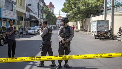Indonesian police stand guard outside the Surabaya police station following another explosion on May 14, 2018. At least 10 people were injured. Ulet Ifansasti / Getty Images