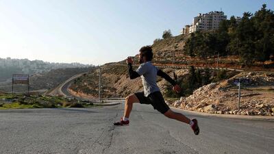 Palestinian Mohammed Khatib training on November 16, 2015 in the West Bank city of Ramallah as part of his preparation for the qualification of the 2016 Summer Olympics to be held in Rio de Janeiro. Khatib, a yoga instructor with a sociology degree, first started dreaming of flying the Palestinian flag after winning a 100-meter sprint a few years ago. Abbas Momani / AFP
