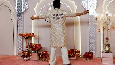 Bollywood actor Arjun Kapoor poses for pictures with a message behind his dress that reads: 'My friend's wedding'. Reuters
