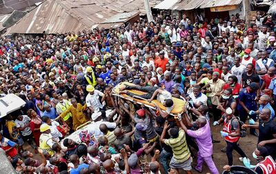 Rescue workers carry a boy rescued from the rubble at the scene of the building collapse. EPA