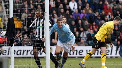 Manchester City’s Edin Dzeko, right, celebrates his equaliser yesterday – his first goal for the club.