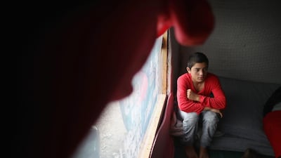 A young migrant children watching a movie inside the Jungle Books Cafe in the Jungle migrant camp on September 6, 2016 in Calais, France. Christopher Furlong/Getty Images