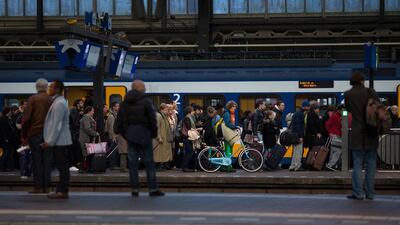 The Netherlands: One commuter stands out at Amsterdam Central station. Jasper Juinen / Bloomberg