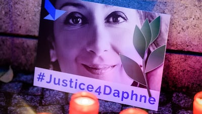'Justice 4 Daphne' is written on a card showing an image of Daphne Caruana Galizia during a picket for the murdered journalist in front of the Maltese embassy in Berlin, Germany, on October 16, 2019.
