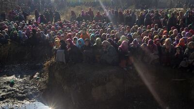 Kashmiri women watch the funeral procession of Farooq Ahmed Bhat who was killed during a demonstration in disputed Kashmir in Palhalan. Dar Yasin / AP Photo