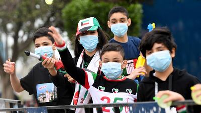 Kuwaiti children use protective masks as they play with a water gun on the country's national day an day in the country's capital. EPA